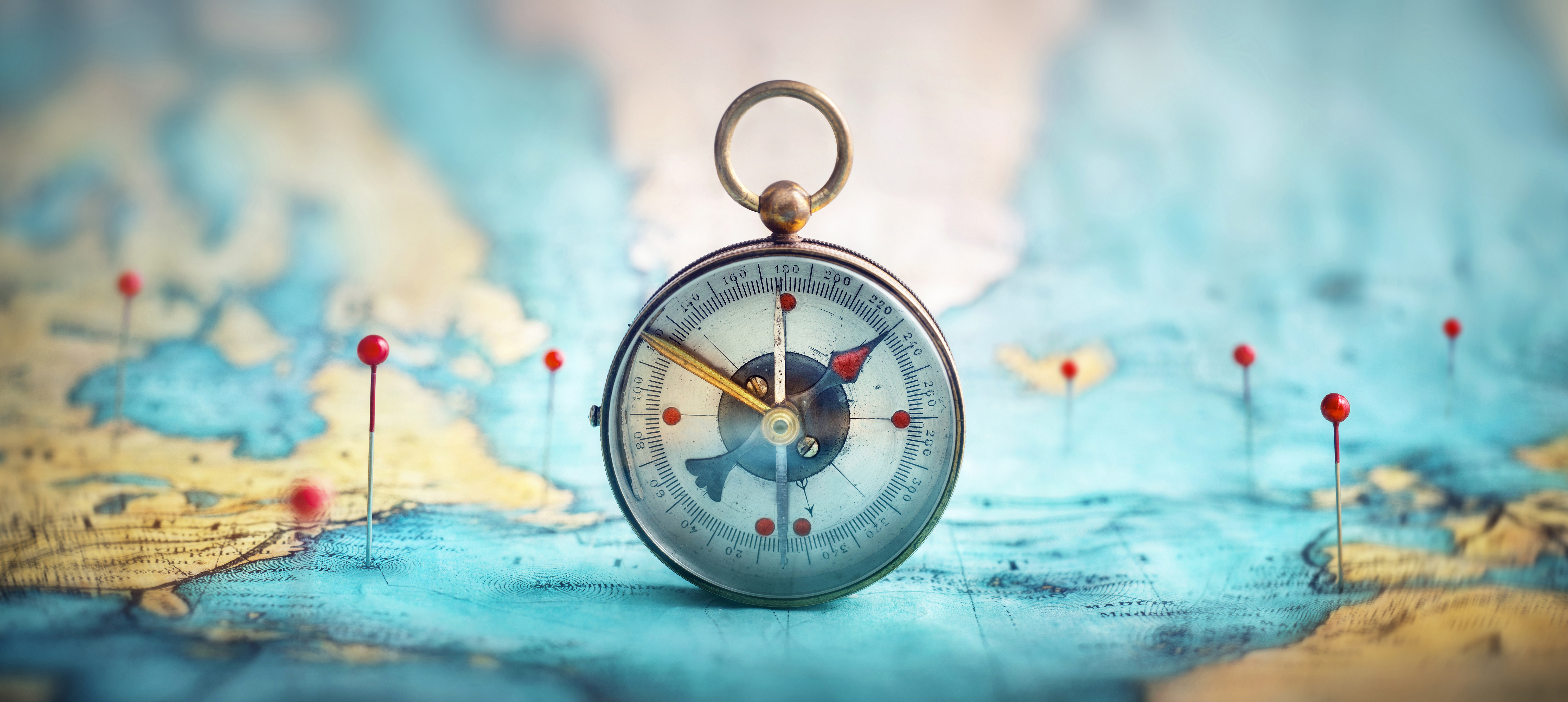 Compass on a world map representing international direction